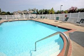 Farmville apartment for rent - a large swimming pool with chairs and a fence around it