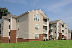 Farmville apartment for rent - a row of apartment buildings on a green field