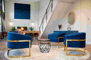 Bound Brook apartment for rent - A living room with blue chairs and a fireplace.