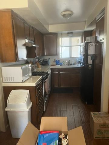 Grover Beach apartment for rent - A kitchen with a white fridge and a white microwave.
