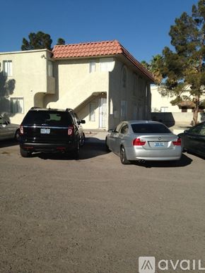 Las Vegas apartment for rent - Two cars parked in front of a house with a sign that says "available".