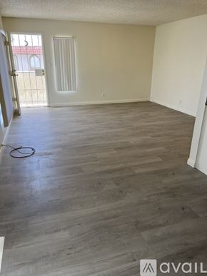 Las Vegas apartment for rent - A room with wooden flooring and a door leading outside.