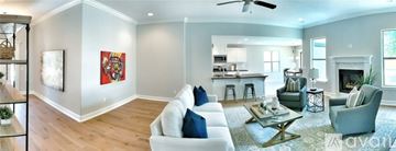 Bentonville house for rent - A living room with a white couch and a fireplace.