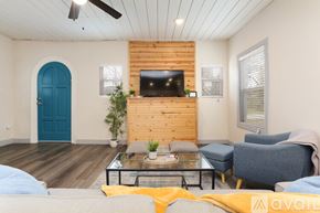 San Antonio house for rent - A living room with a blue door and a wooden wall.