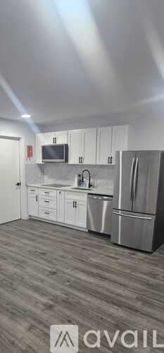 Scotch Plains house for rent - A kitchen with white cabinets and stainless steel appliances.