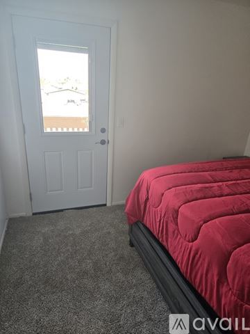 Phoenix condo for rent - A living room with a brown couch and a flat screen TV mounted on the wall.