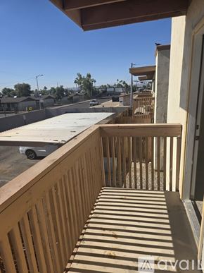 Phoenix condo for rent - A balcony with a view of a parking lot and buildings.