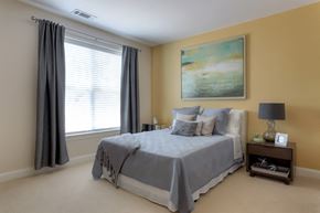 Farmington apartment for rent - a bedroom with a bed and a painting on the wall