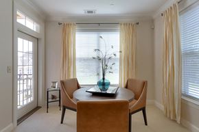 Farmington apartment for rent - a dining room with a table and chairs in front of a window