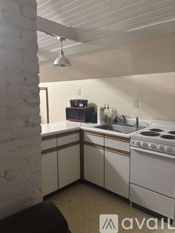 Marysville apartment for rent - A kitchen with white cabinets and a stove top oven.