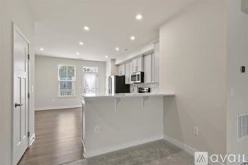 Myrtle Beach house for rent - A spacious kitchen with white cabinets and a large island.