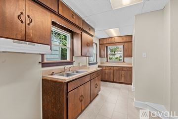 Toledo house for rent - A kitchen with wooden cabinets and a white countertop.