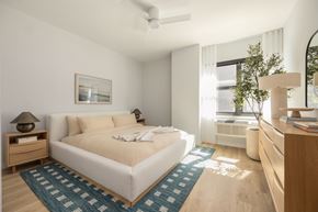 Asbury Park apartment for rent - A bedroom with a large bed and a ceiling fan.
