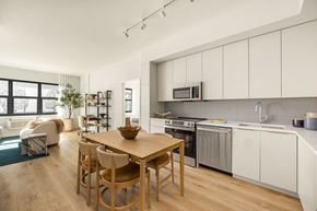 Asbury Park apartment for rent - A modern kitchen with a wooden table and chairs.