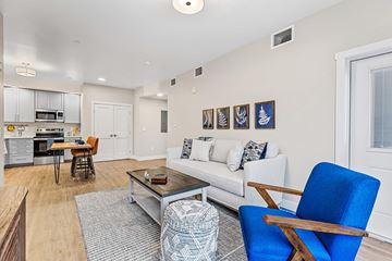 Flagstaff apartment for rent - A living room with a white couch and a blue chair.