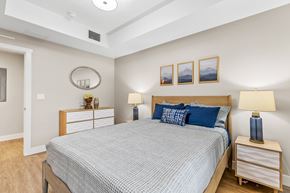 Flagstaff apartment for rent - A bedroom with a bed, nightstands, and pictures on the wall.