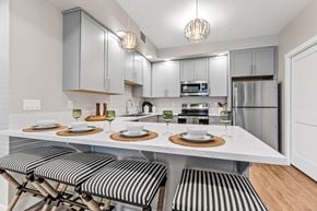 Flagstaff apartment for rent - A modern kitchen with a dining table set for two.