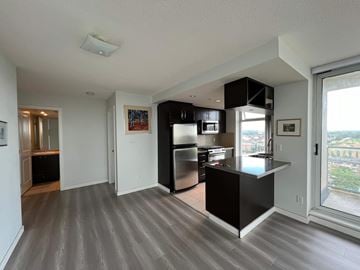 Richmond apartment for rent - A modern kitchen with a black countertop and stainless steel appliances.