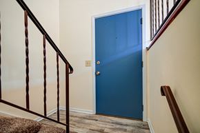 Madison house for rent - A blue door is at the end of a staircase.