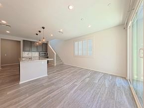 Chino house for rent - A spacious room with wooden flooring and a staircase leading to the upper level.
