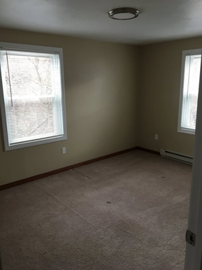 Athol apartment for rent - A room with a carpeted floor and two windows.
