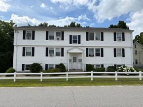 Athol apartment for rent - A white two-story house with black shutters and a white fence.