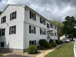 Athol apartment for rent - A white two-story house with black shutters and a grey car parked in front.