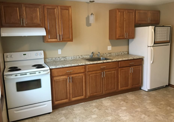 Athol apartment for rent - A kitchen with a white stove and a white refrigerator.