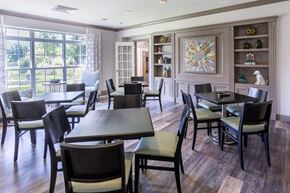 Middle Island apartment for rent - a dining room with tables and chairs and a window