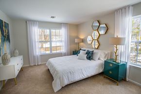 Middle Island apartment for rent - a bedroom with a bed and two windows