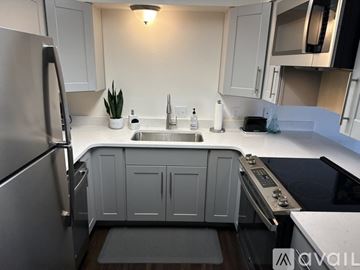 Roseburg apartment for rent - A modern kitchen with a stainless steel refrigerator and a white sink.