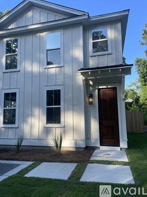 Charleston apartment for rent - A white house with a brown door and windows.
