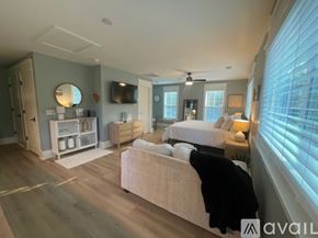 Charleston apartment for rent - A bedroom with a large bed and a flat screen TV mounted on the wall.