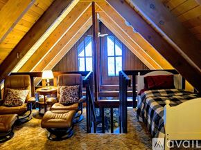 Truckee house for rent - A cozy bedroom with a large bed and a window.
