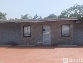 Miami house for rent - A house with a white door and windows is available for rent.