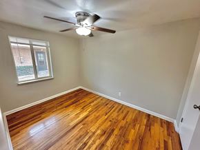 Lakewood apartment for rent - A room with a ceiling fan and wooden flooring.