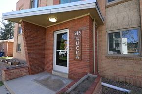 Denver apartment for rent - A brick building with a door and a sign that says 815 Lucca.