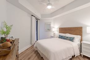 Cape Coral apartment for rent - A bedroom with a bed, nightstand, and a plant.