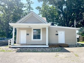 Louisville apartment for rent - A small house with a white door and a window is surrounded by trees.