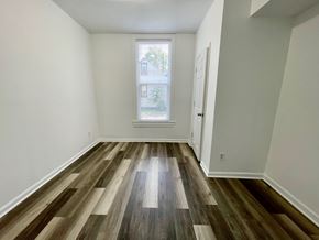 Louisville apartment for rent - A room with a window and wooden flooring.