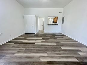 Louisville apartment for rent - A room with a wooden floor and white walls.