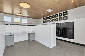 Erie apartment for rent - A modern kitchen with a white counter and black cabinets.