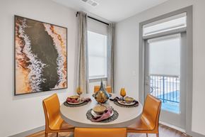 Erie apartment for rent - A dining room with a large painting on the wall and a table set for a meal.