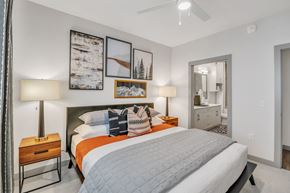 Erie apartment for rent - A bedroom with a large bed and a ceiling fan.