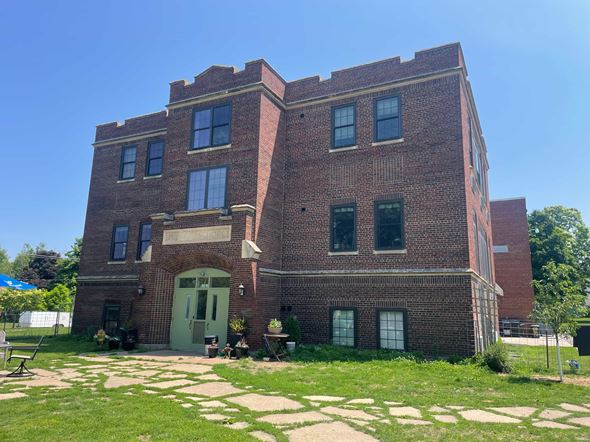 Menomonie apartment for rent - A red brick building with a green door and windows.