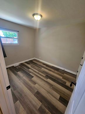 St Louis house for rent - A room with wooden flooring and a window.