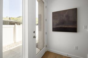 Salt Lake City townhouse for rent - A painting hangs on a white wall in a room with a white door.