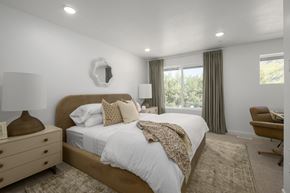 Salt Lake City townhouse for rent - A bedroom with a large bed and a chair.