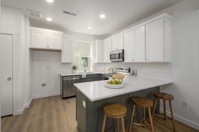 Salt Lake City townhouse for rent - A kitchen with white cabinets and a white counter top.