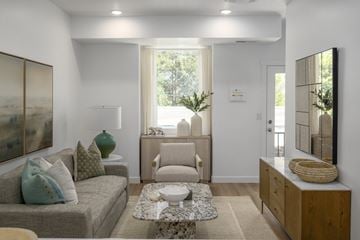 Salt Lake City townhouse for rent - A living room with a grey couch, a coffee table, and a painting on the wall.